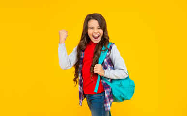 successful kid has long curly hair carry school backpack on yellow background, knowledge