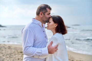 Fototapeta premium Mature happy loving couple kissing on the sea beach.