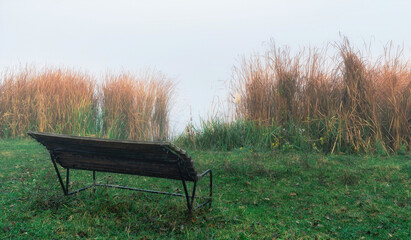 Empty bench near a misty lake	 - 480163125