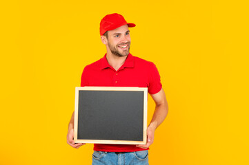 happy guy with bristle holding chalkboard with copy space on yellow background, advertisement