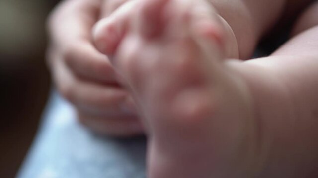 Baby Feet On Mother Hands. Cute Tiny Newborn Kid's Legs On Female Embrace Closeup. Mom And Her Child. Happy Family Concept. Beautiful Conceptual Video Of Maternity. Adorable Tiny Toes Selective Focus
