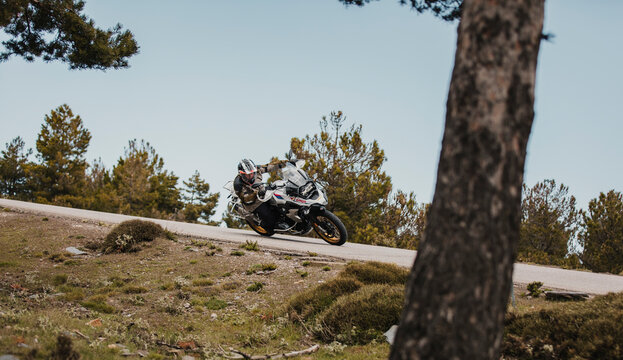 Sierra de los Filabres, Spain - May 5th 2021: Motorbike rider riding BMW R 1250 GS motorcycle in a mountain road across beautiful turns, during Dunlop Xperience event in Sierra de los Filabres, Spain.