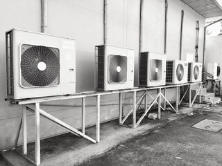 White air conditioner condenser unit outside the building.	