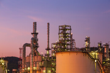 Oil​ refinery​ and​ plant of petrochemistry industry tank oil​ and​ gas​ ​industry with​ cloud​ ​sky the sunset