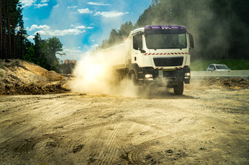 Loaded moving truck on a dirt road at a construction site