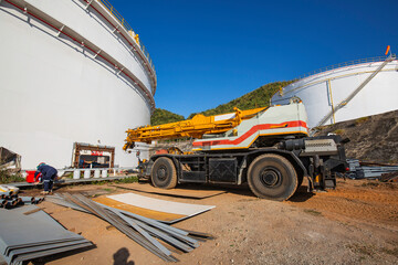 Crane on a road in construction site industrial storage tank oil