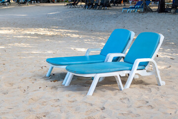 Blue color of beach chairs on sand.