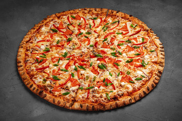 Pizza with pumpkin seeds, feta and green onions on a gray concrete background.