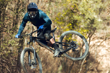 Close up of Boy jumping with enduro mtb bike in bike park