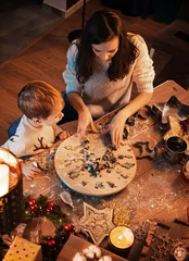 Tuinposter Happy beautiful family, mother and son preparing for Christmas together at home © konradbak