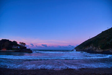 beautifully colored sunset on a rocky beach