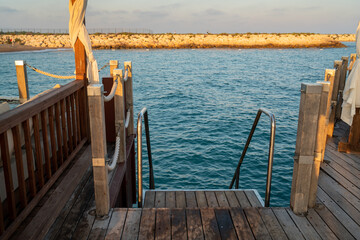 Ladder pier on the wooden platform to enter the sea