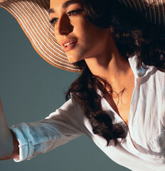 Beautiful young lady wearing straw hat