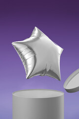 Shot of a balloon shaped as a silver star. The silver balloon is flying out of a box. The photo is taken on a violet background.