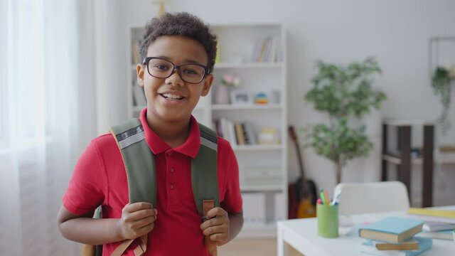 Portrait of smiling African American boy with backpack, first day of school