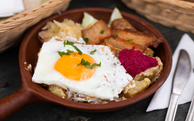 Breakfast dish - scrambled eggs with fried bacon