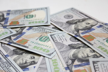 100 dollar US banknotes placed on a white background.