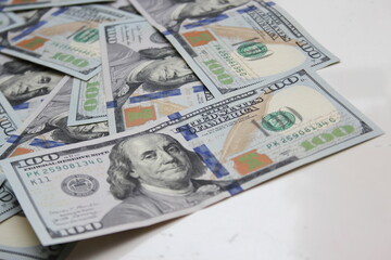 100 dollar US banknotes placed on a white background.