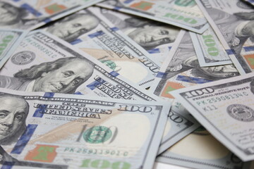 100 dollar US banknotes placed on a white background.