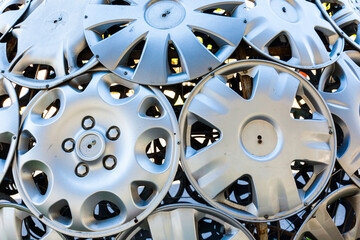 Old wheel caps screwed to metal.