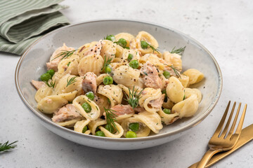Orecchiette pasta with smoked salmon, green peas, creamy sauce and dill. Healthy food.