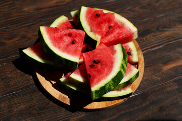 Ripe sliced watermelon on wooden background