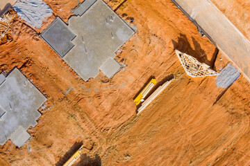 Building site of trenches dug in ground and filled with cement as foundation for future house
