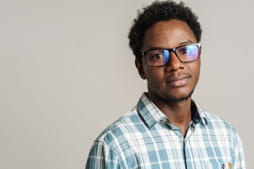 Young black man wearing eyeglasses posing and looking at camera