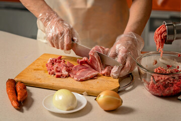 female hands cutting meat for minced meat