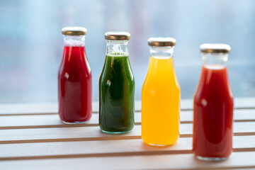 glass bottles with colorful fresh juice, fruit, and vegetable smoothies. bottle of juice