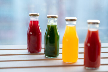 glass bottles with colorful fresh juice, fruit, and vegetable smoothies. bottle of juice