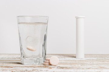 Effervescent tablet dissolved in a glass of water. Vitamin and nutrient supplement for healthy lifestyle