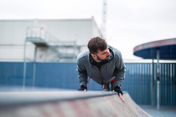 Young man exercising in urban setting
