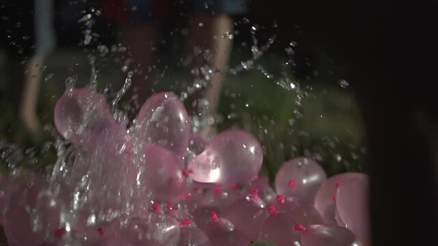 Slow Motion Water Balloons Filling Setup Preparation and Release with many connected straws and tubes with a hose splash
