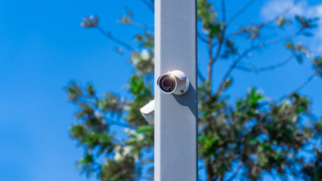 CCTV surveillance security camera video equipment on pole outdoor area safety system area control and copy space
