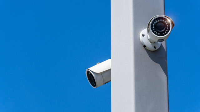CCTV surveillance security camera video equipment on pole with blue sky outdoor area safety system area control and copy space