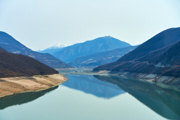 Zhinvali reservoir in the mountains of Georgia. Azure water on a background of mountains