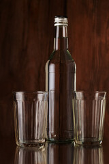 Faceted glasses and a bottle of vodka