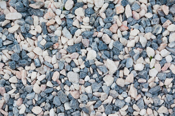 Stones of different shapes, sizes and colors on the seashore, close-up. Background of sea stones.