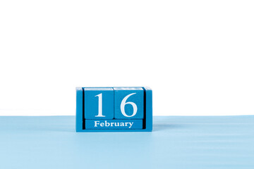 Wooden calendar February 16 on a white background