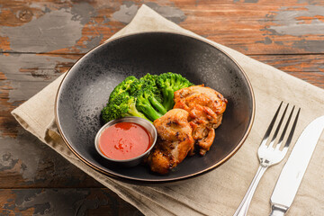 Chicken kebab with broccoli cabbage, on a wooden background