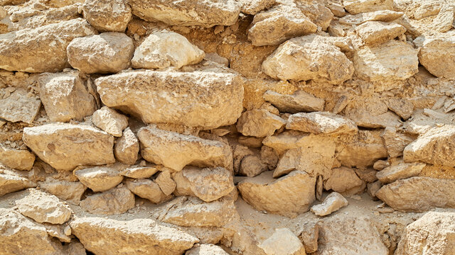 Old beige stone wall background texture