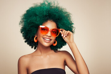 Beauty portrait of African American girl in colored sunglasses. Beautiful black woman. Cosmetics,...