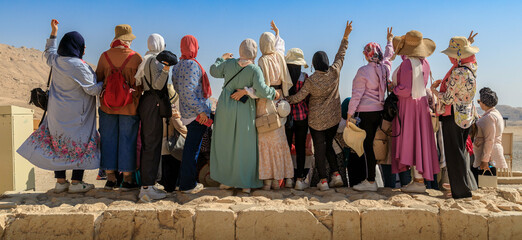 Muslimische Mädchengruppe posiert für ein Foto auf einer Steinmauer, Panoramafoto