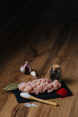 raw minced fresh meat on a wooden background spice pepper wooden spoon