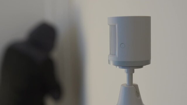 Security alarm motion sensor on the wall of the house, wireless motion detector detects burglar intrusion sends an alarm signal. Smart home devices. High quality 4k footage