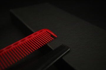 two flat combs from a professional hairdressing set lie on a black background
