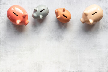 Many piggy bank - different types of currency saving and investments