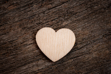 Wooden heart on wooden dark background