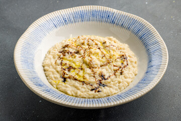 risotto four cheeses on grey concrete table